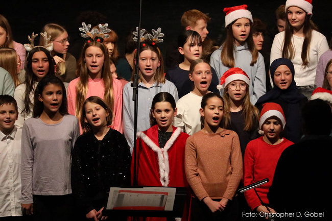 Chorschüler teils mit weihnachtlicher Verkleidung